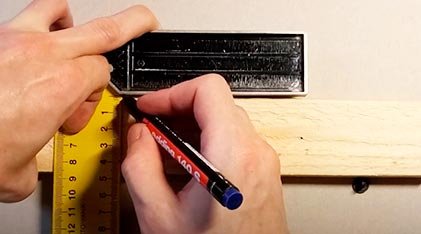 Cut the wooden board to the required size. Use a pencil to mark where the blade and the guide will be installed.