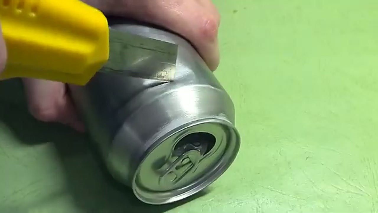 Cutting a rectangular strip from an aluminum beverage can
