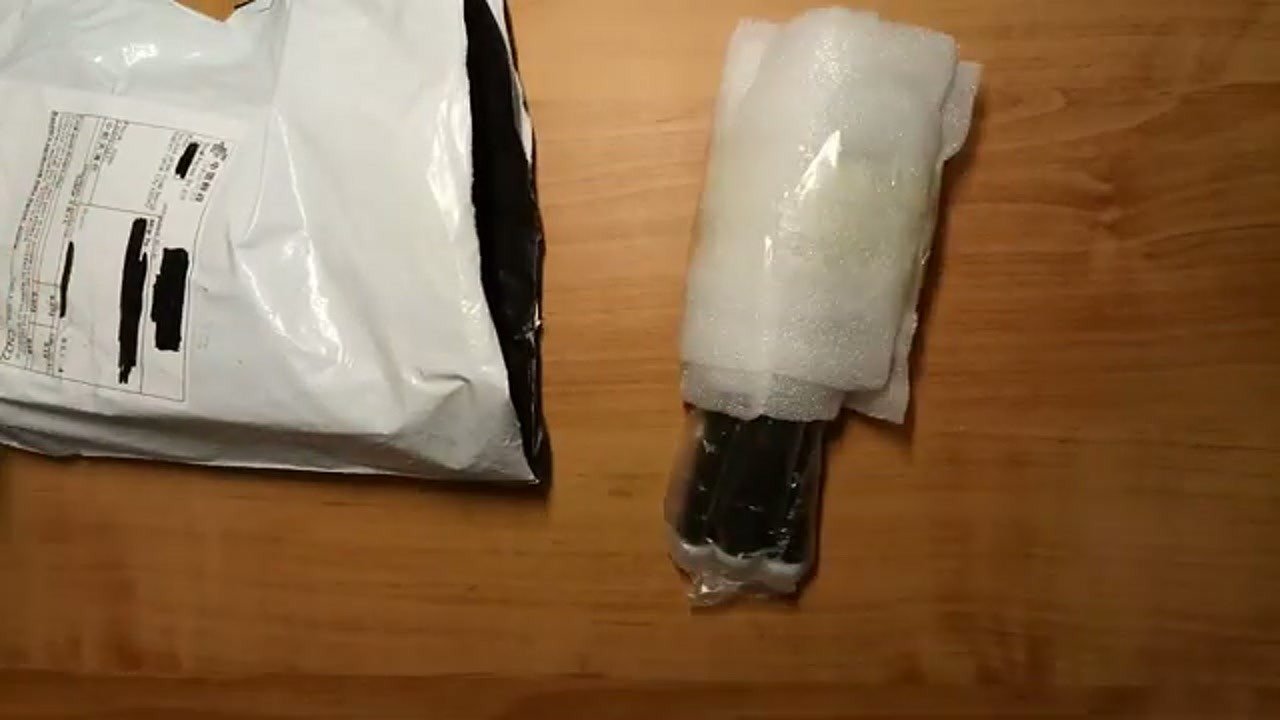 Unboxing the kebidu flexible octopus tripod on a wooden table