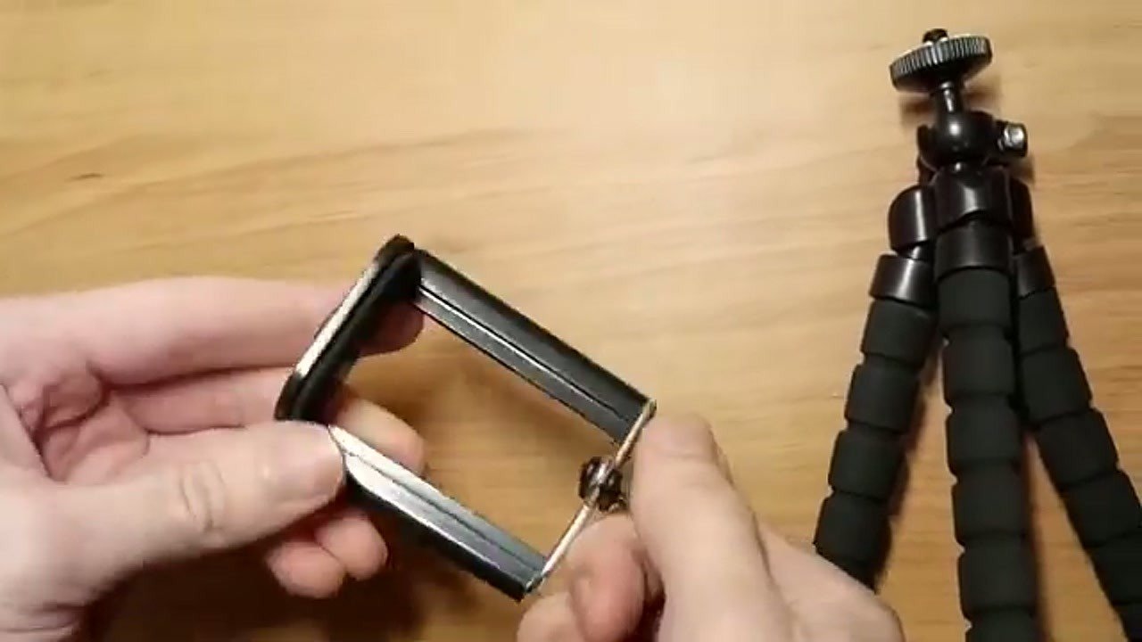 Assembling the spring-loaded phone holder onto the tripod