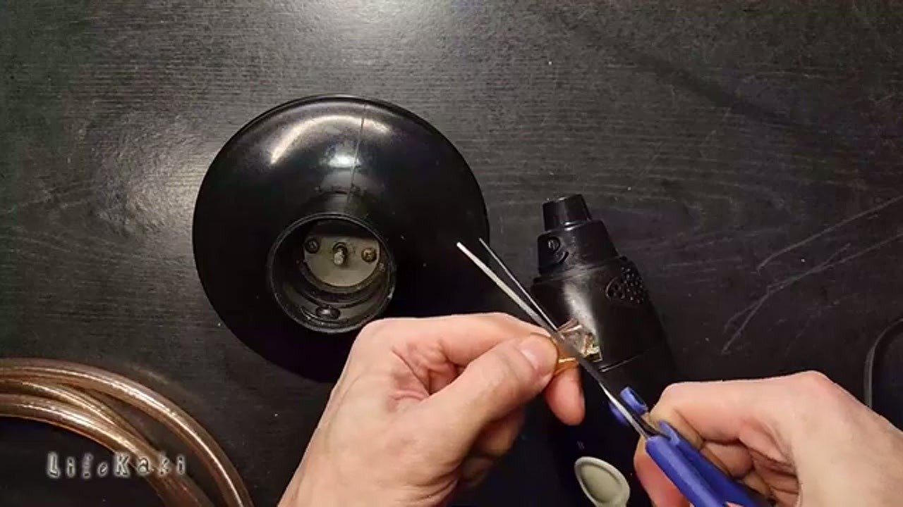 Inspecting the worn plastic coupling on the blender motor shaft