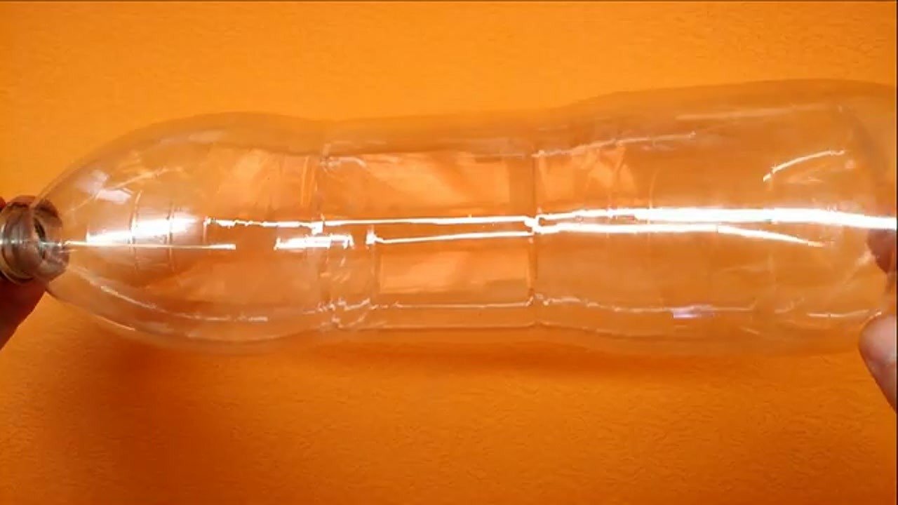 Assessing the cabinet space with a clear plastic bottle