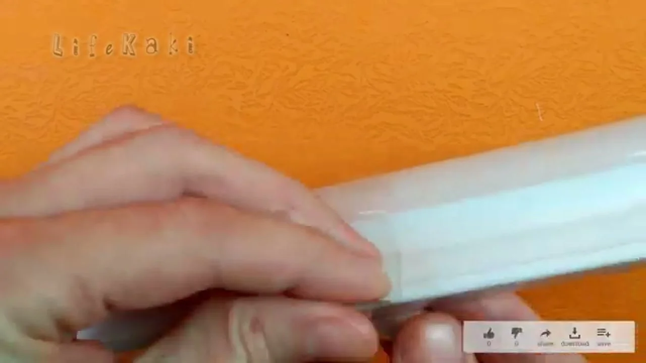 Cutting a thin strip from the plastic bottle