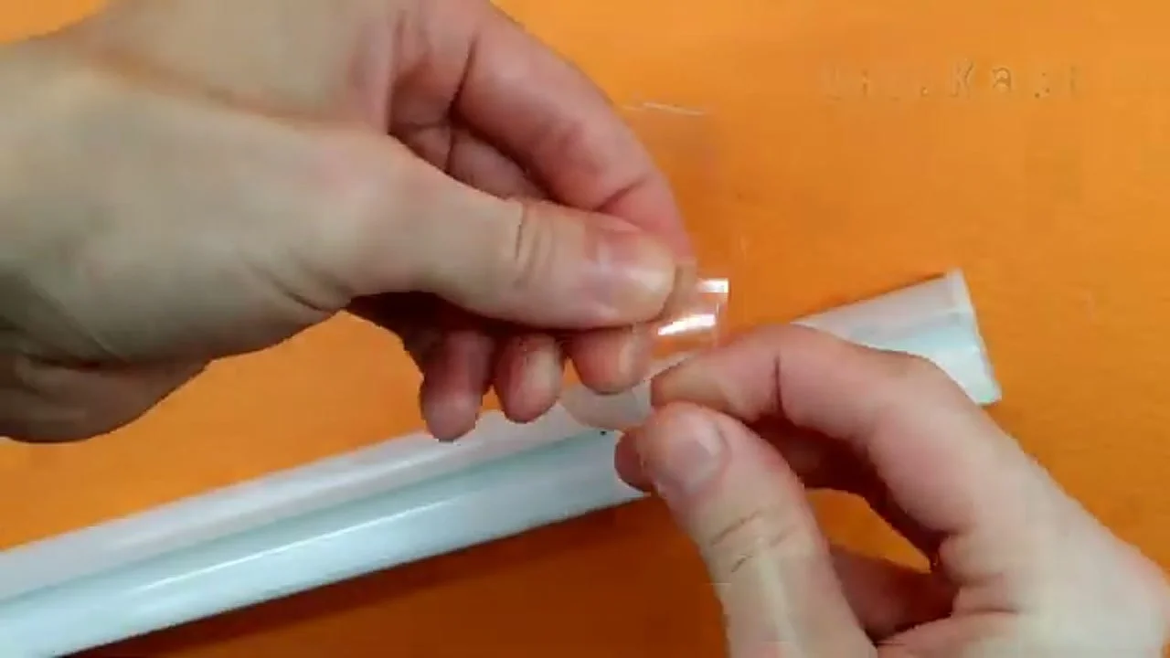 Aligning the plastic piece on a wooden block