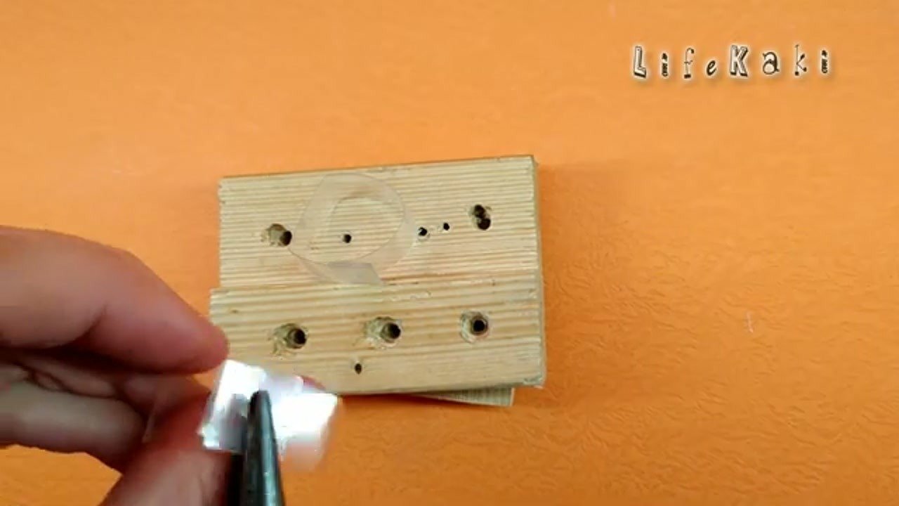 Punching holes in the bracket and attaching to the light