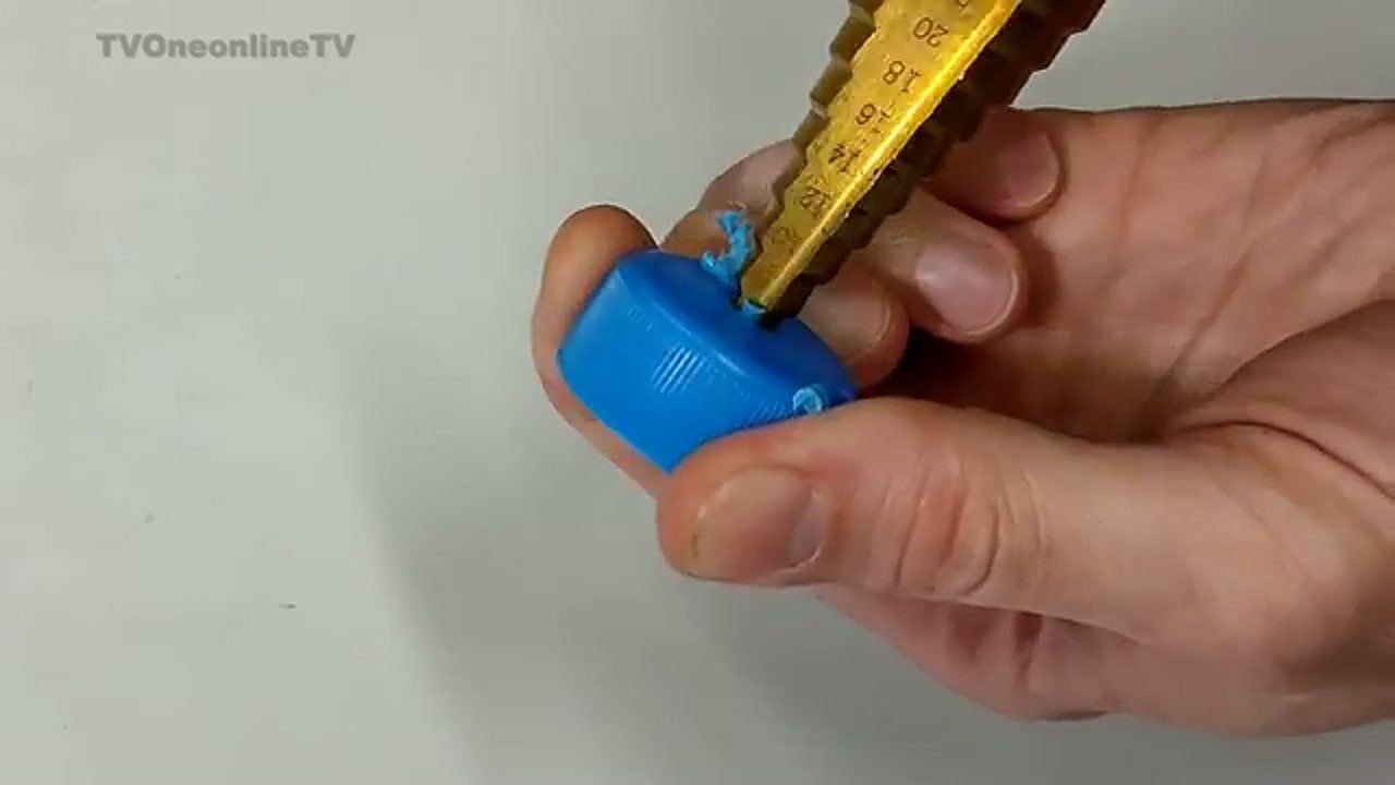 Drilling center hole in plastic bottle cap with step drill