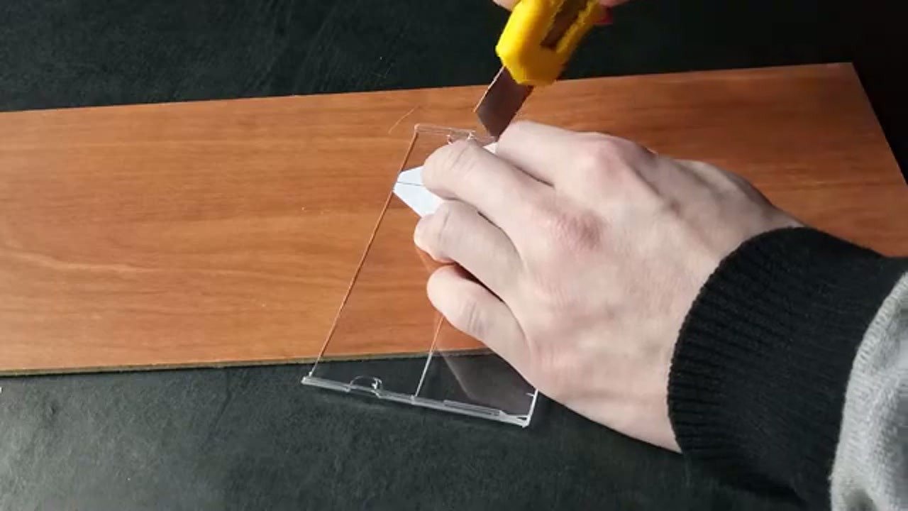 Cutting the CD case plastic using a craft knife
