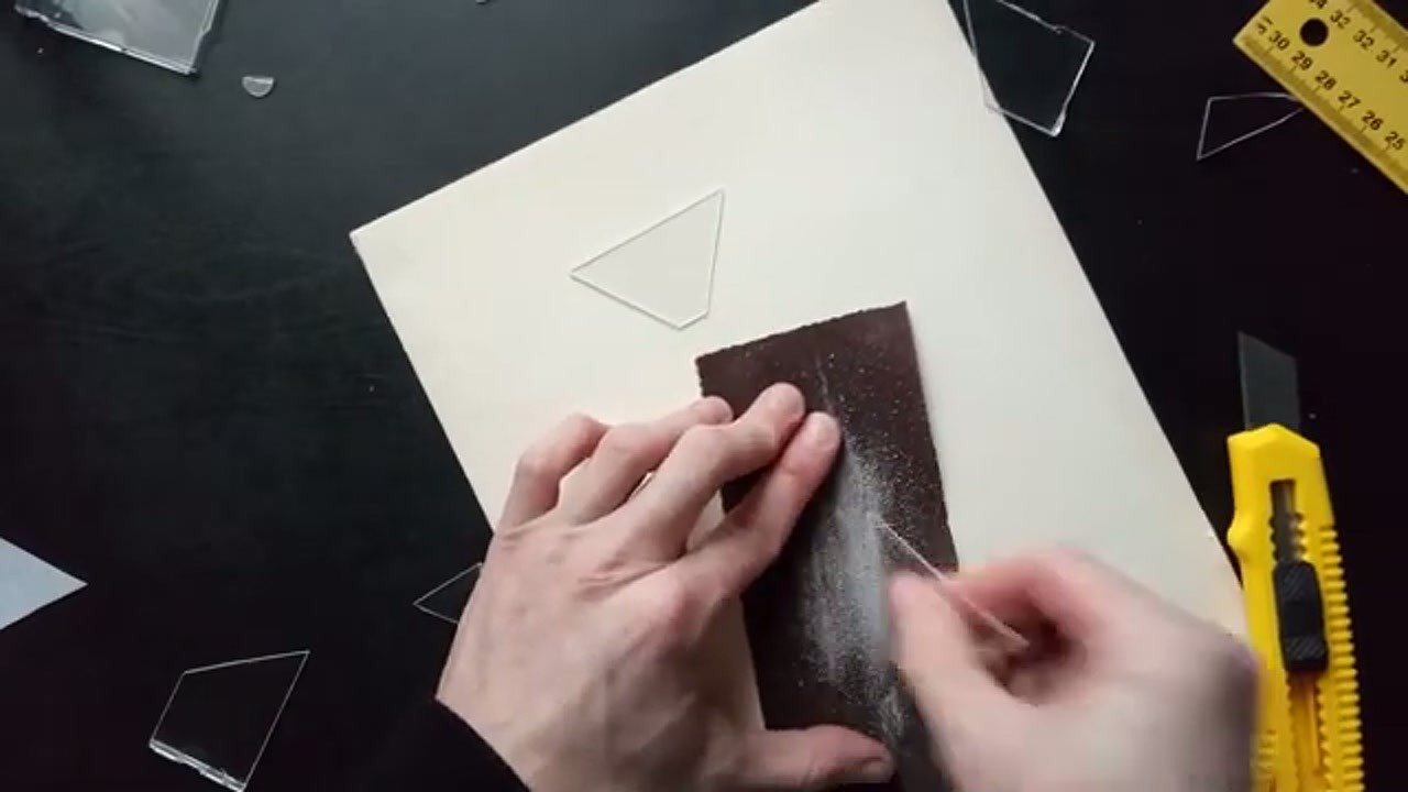 Sanding the edges of the plastic pieces for a smooth fit