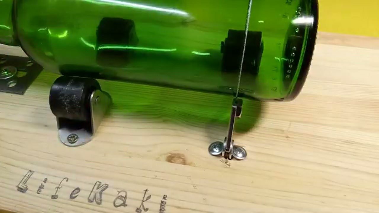Scoring a green glass bottle with the custom tool