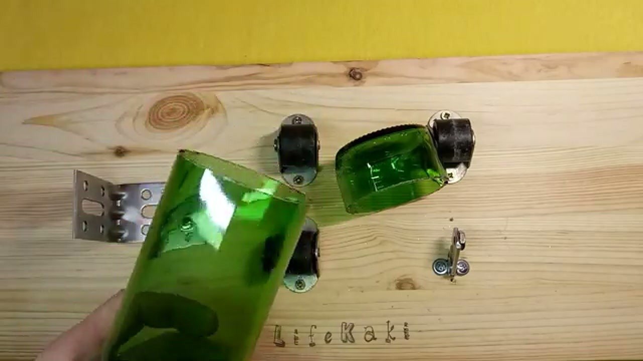 Cut glass bottles being sanded for use as holders