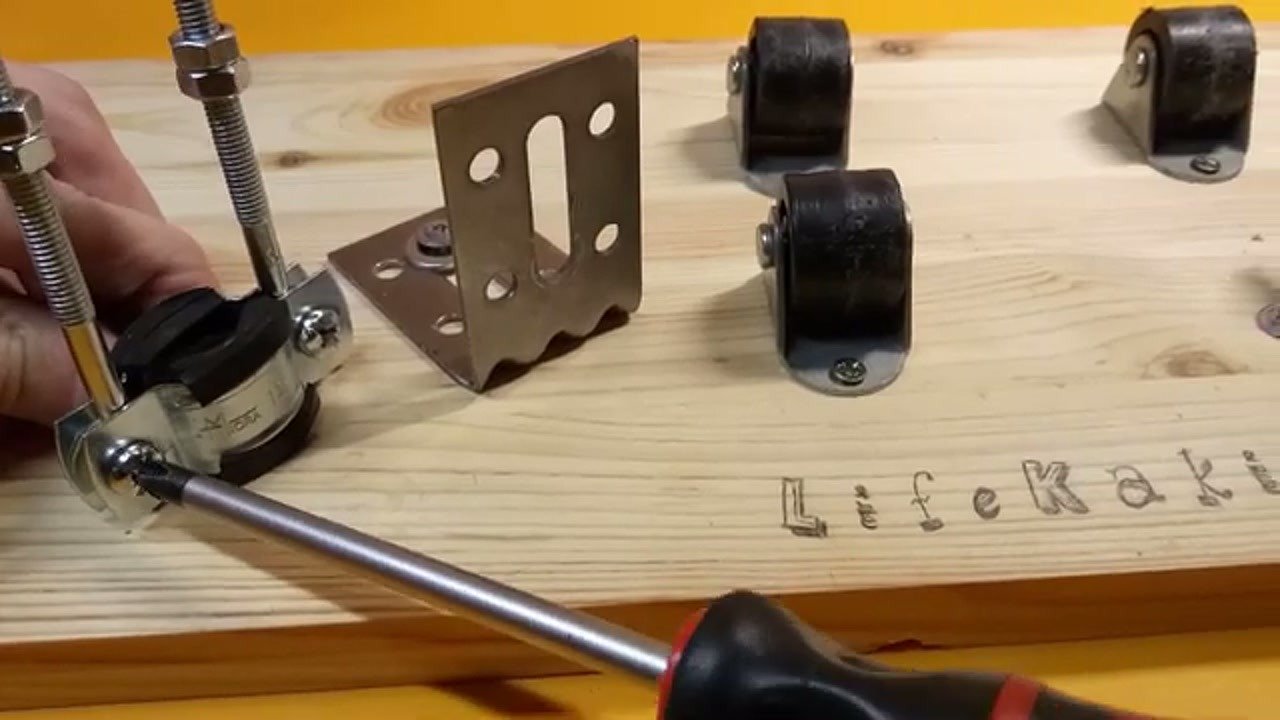 Screwing the metal bracket onto the wooden workbench