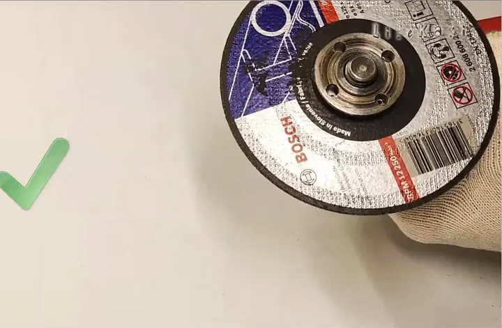 Removing loosened flange nut and taking off old cutting wheel