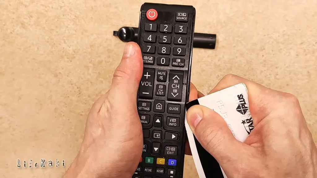 Prying open the remote casing with a plastic tool