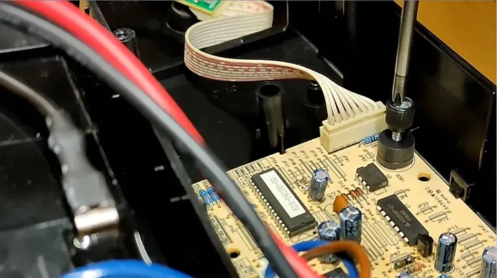 Removing rubber base feet to access the hidden screws