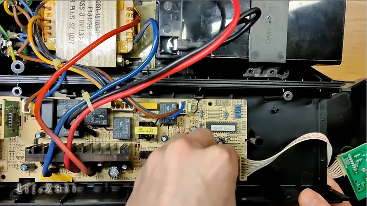 Disconnecting white ribbon wiring to expose the buzzer element