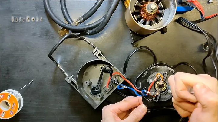 Soldering the repaired 12V wire to motor connector