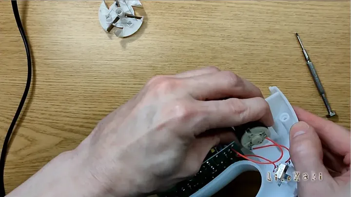 Clear close up of hands assembling device components inside the housing