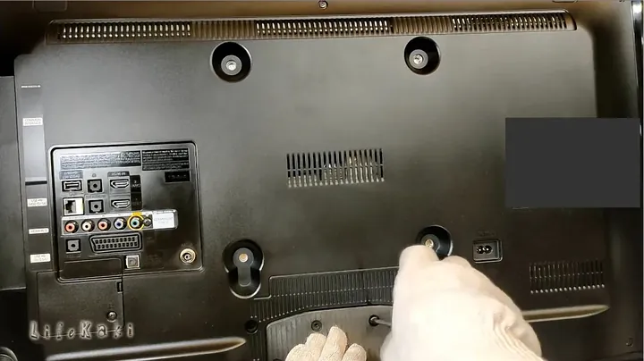 Hands working on reassembling the TV casing